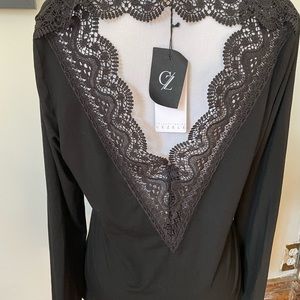 Brand New Medium black long sleeve top, lace detail on back. New with tags.
